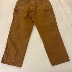 Carhartt B11 BRN loose-fit washed-duck work dungaree pants in brown.